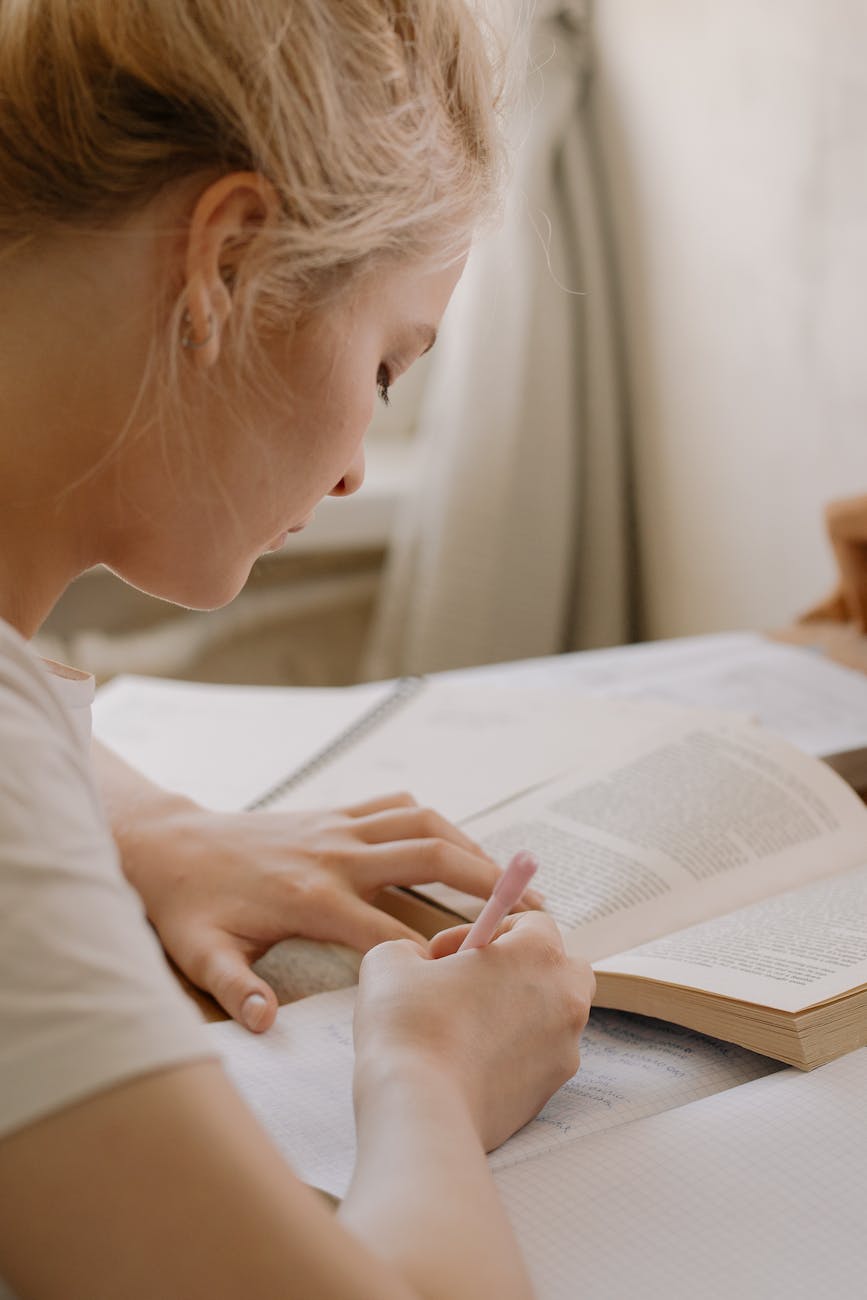 girl in white shirt reading book